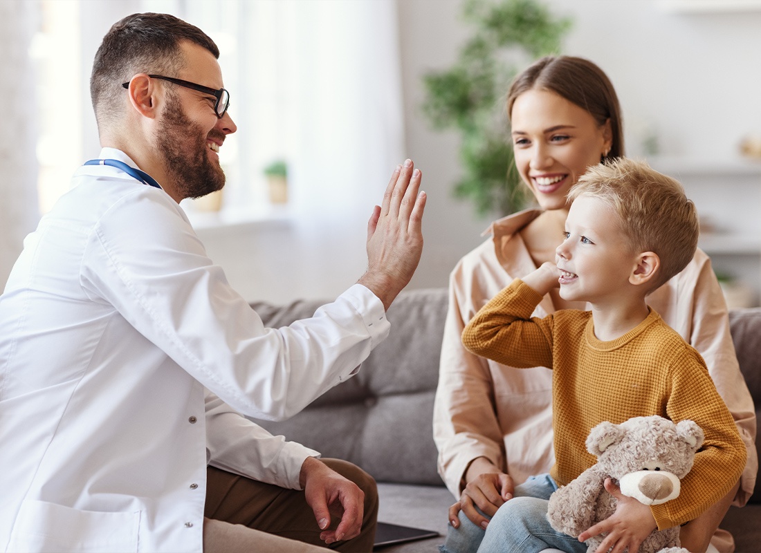 Employee Benefits - Doctor and Small Child Giving Each Other a High Five